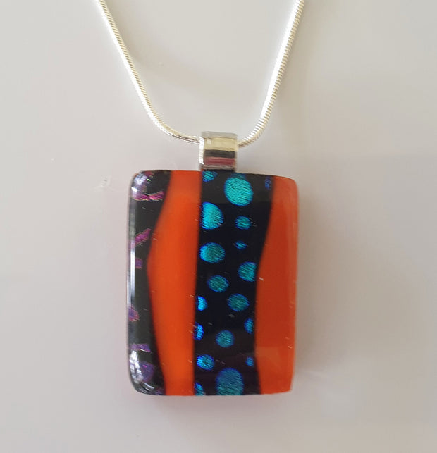 red pendant with blue and purple dichroic pattern