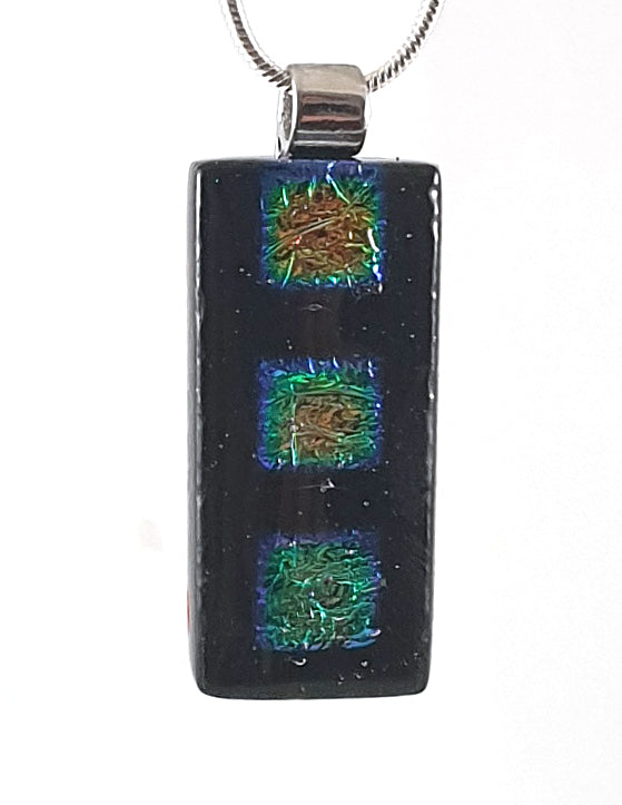 Black pendant with squares of gold and green 