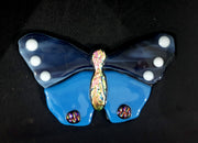 Blue butterfly with pink and green dichroic body