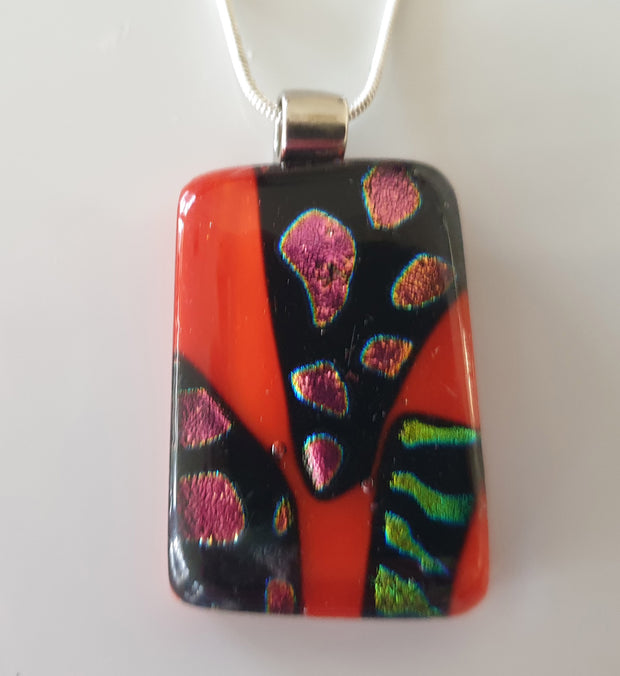 red pendant with purple and green dichroic design