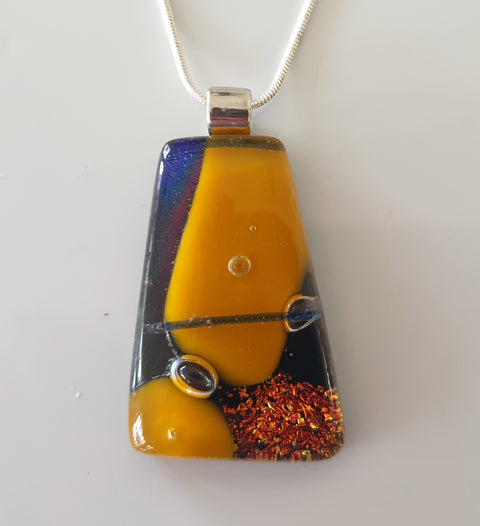 pumpkin and gold dichroic pendant with 3 bubbles encased