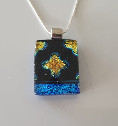 small black and blue pendant with gold dichroic