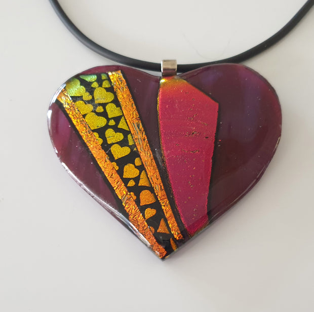 Large burgundy red heart shaped pendant with small golden dichroic hearts