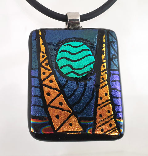hand engraved dichroic pendant with blue moon  between gold triangles on black neoprene necklace