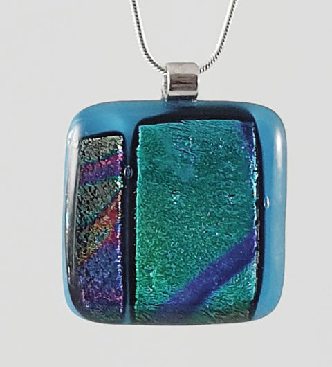 blue background with green and blue dichroic glass. 4 cm x 4 cm on 44 cm chain