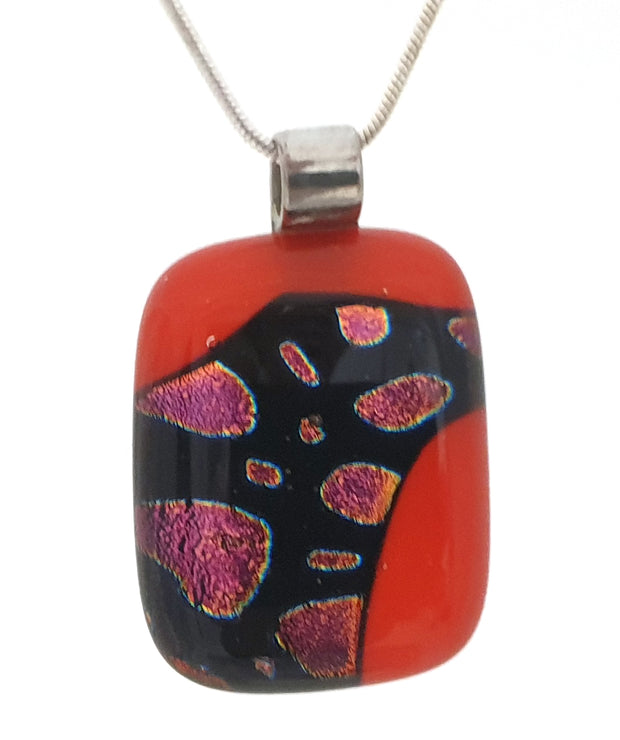 red pendant with mauve and black dichroic pattern